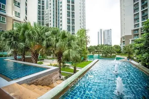Luxurious condominium complex with lush gardens and stunning water features.