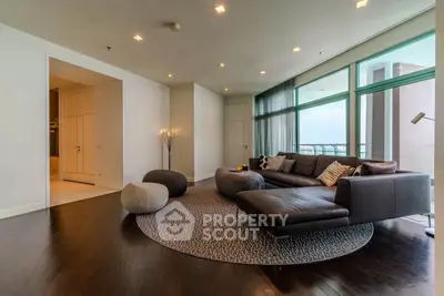 Spacious modern living room with large windows and stylish furniture