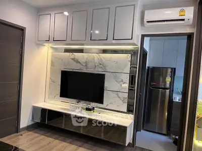 Modern living room with sleek TV unit and air conditioning, featuring stylish cabinetry and marble accents.