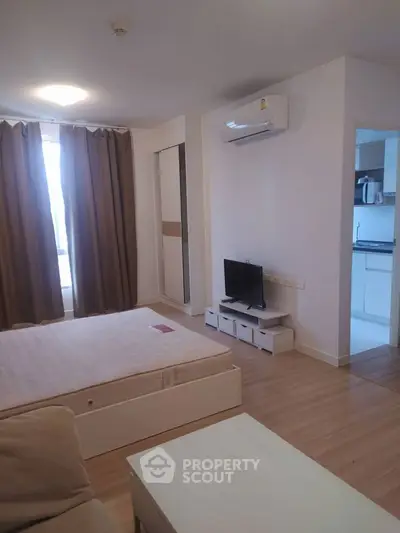 Cozy bedroom with modern decor and ample natural light