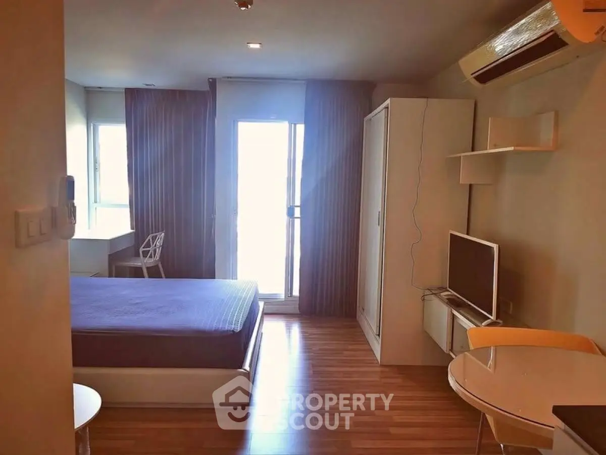 Modern studio apartment with cozy bedroom and stylish furnishings.
