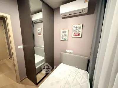 Cozy bedroom with mirrored wardrobe and air conditioning, perfect for comfortable living.