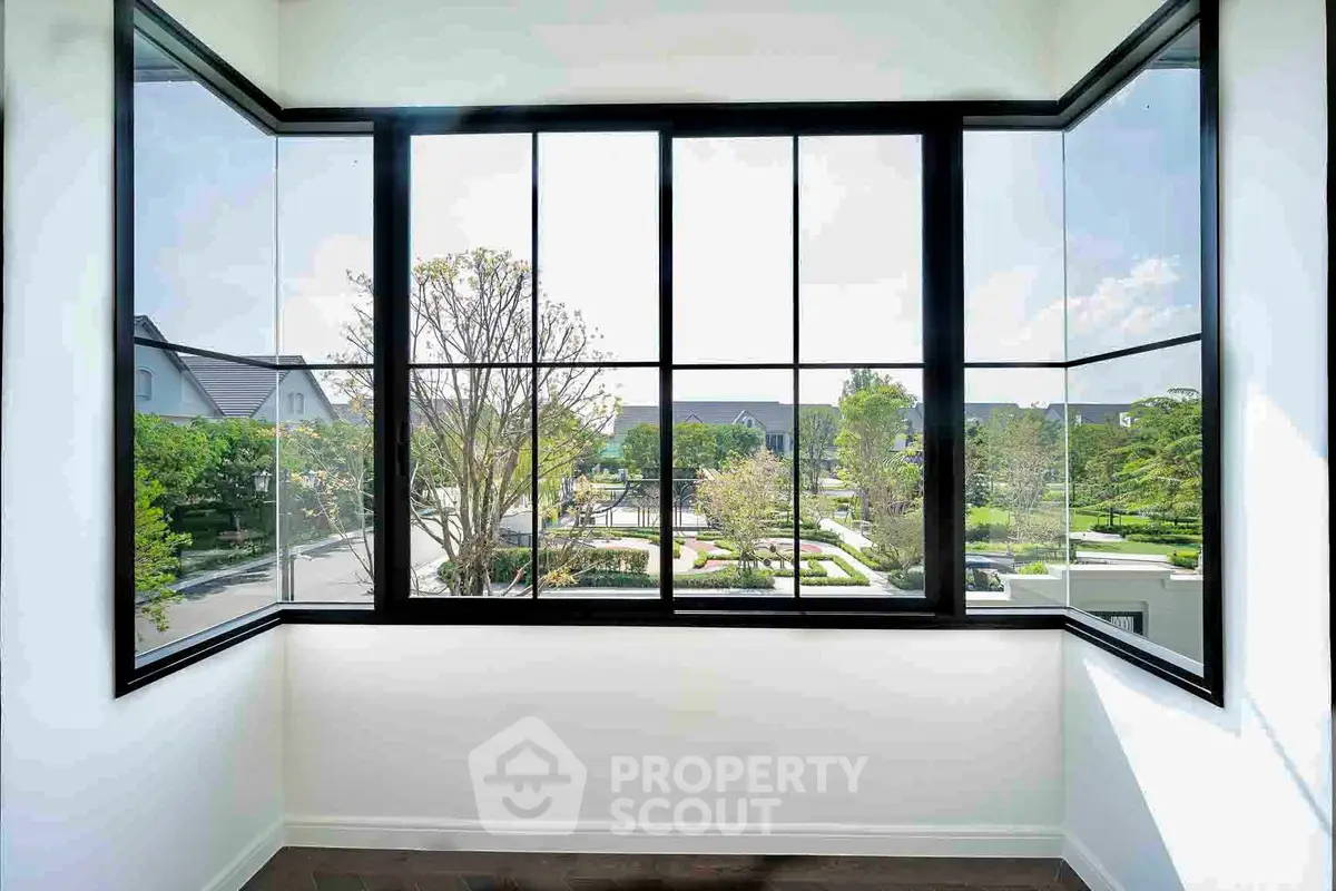 Stunning corner unit with expansive windows offering a great view of lush greenery and modern architecture.