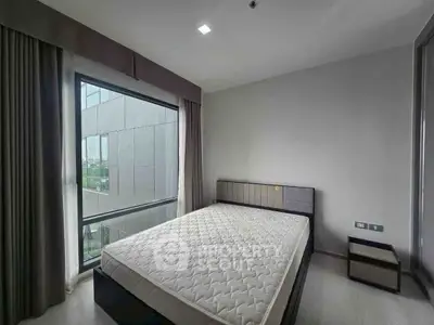 Modern bedroom with large window and minimalist design in urban apartment
