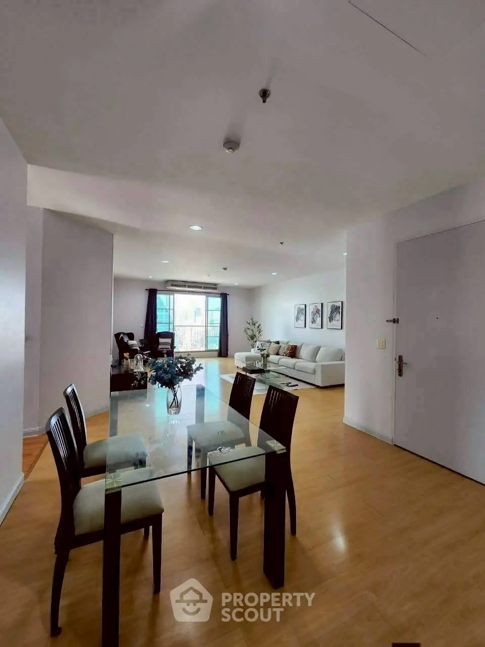 Spacious open-plan living and dining area with modern decor and natural light.