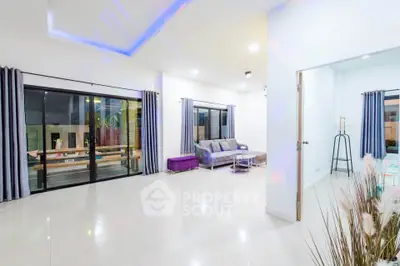 Spacious modern living room with sleek design and large windows for natural light.
