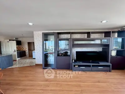 Spacious living room with modern entertainment center and city view