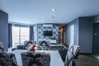 Spacious modern living room with elegant dining area and balcony view
