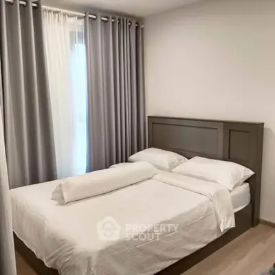 Cozy bedroom with elegant curtains and modern bed frame, perfect for relaxation.