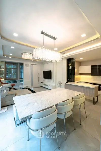 Luxurious open-plan living and dining area with modern kitchen and elegant lighting