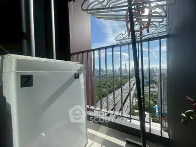 Stunning city view from high-rise balcony with laundry area and modern appliances.