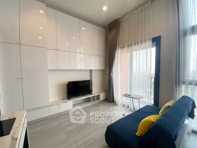 Modern living room with sleek cabinetry and balcony view