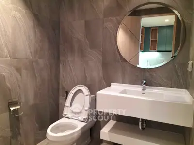Modern bathroom with sleek design and round mirror