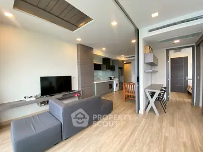 Modern open-plan living room with sleek kitchen and stylish decor