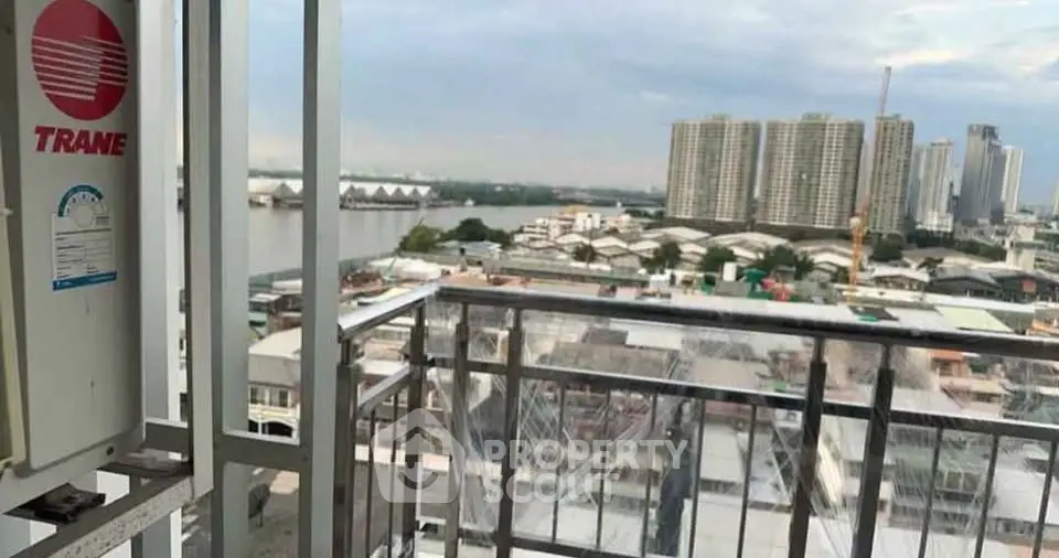 Stunning cityscape view from a high-rise balcony overlooking river and skyline.