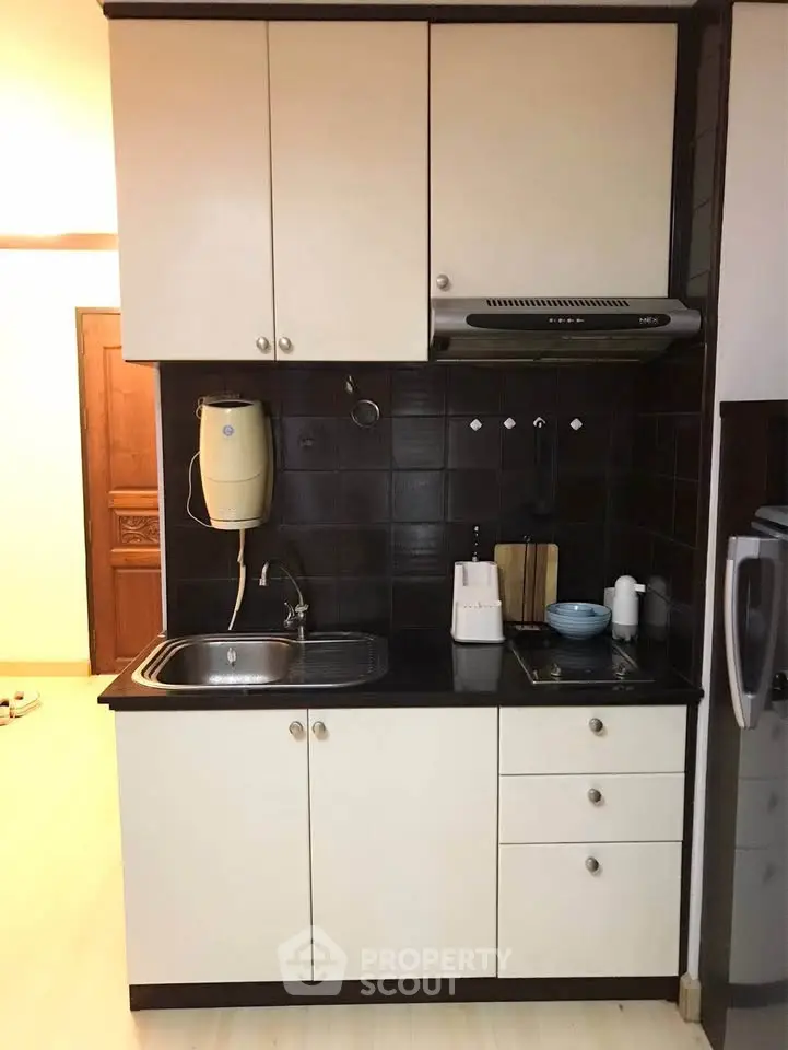 Compact kitchen with sleek cabinetry and modern appliances