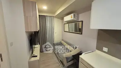 Cozy living room with modern furniture and air conditioning in a compact apartment.