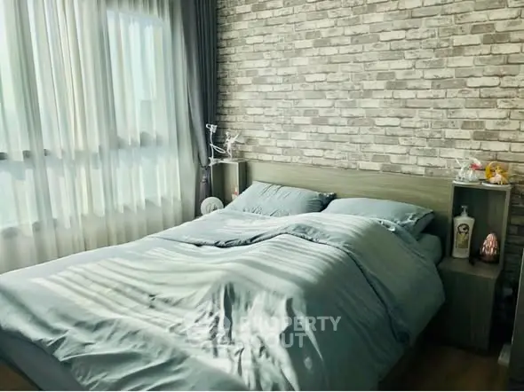 Cozy bedroom with brick accent wall and soft natural lighting