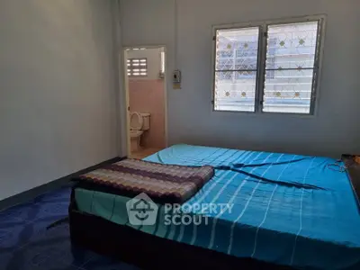 Cozy bedroom with attached bathroom and natural light