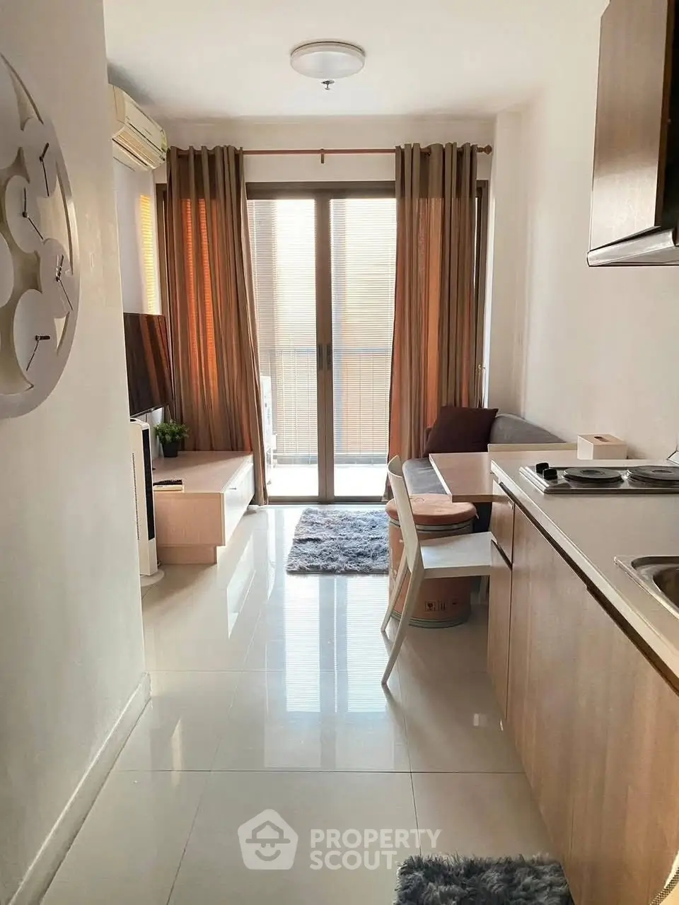 Cozy modern living room with natural light and compact kitchen area