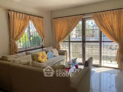 Bright living room with large windows and cozy seating area