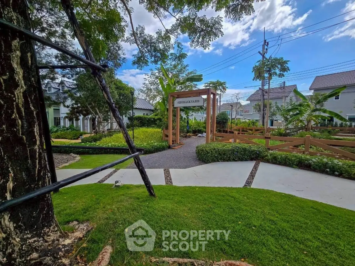 Charming residential garden with lush greenery and inviting pathways in a serene neighborhood setting.