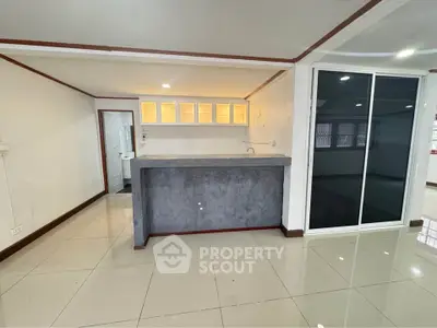 Spacious open-plan kitchen with modern design and ample natural light