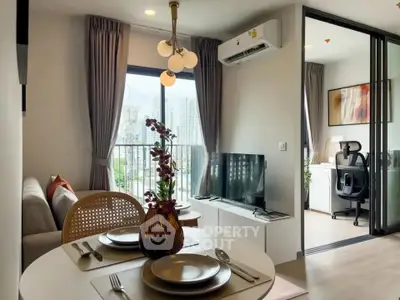 Modern living room with balcony view and stylish dining area in a contemporary apartment.