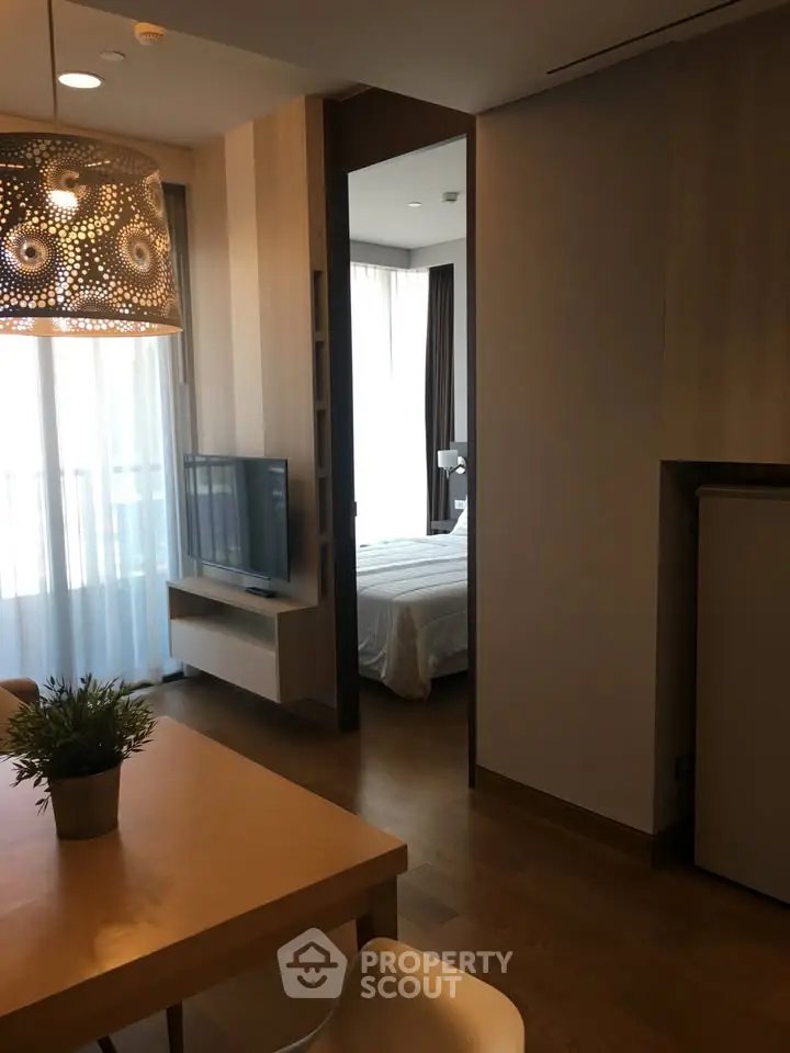 Modern apartment interior with open living area and cozy bedroom view.