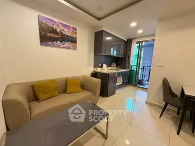 Modern living room with cozy sofa, sleek kitchen, and balcony view in stylish apartment.