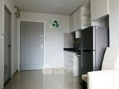 Modern compact kitchen with sleek appliances and minimalist design