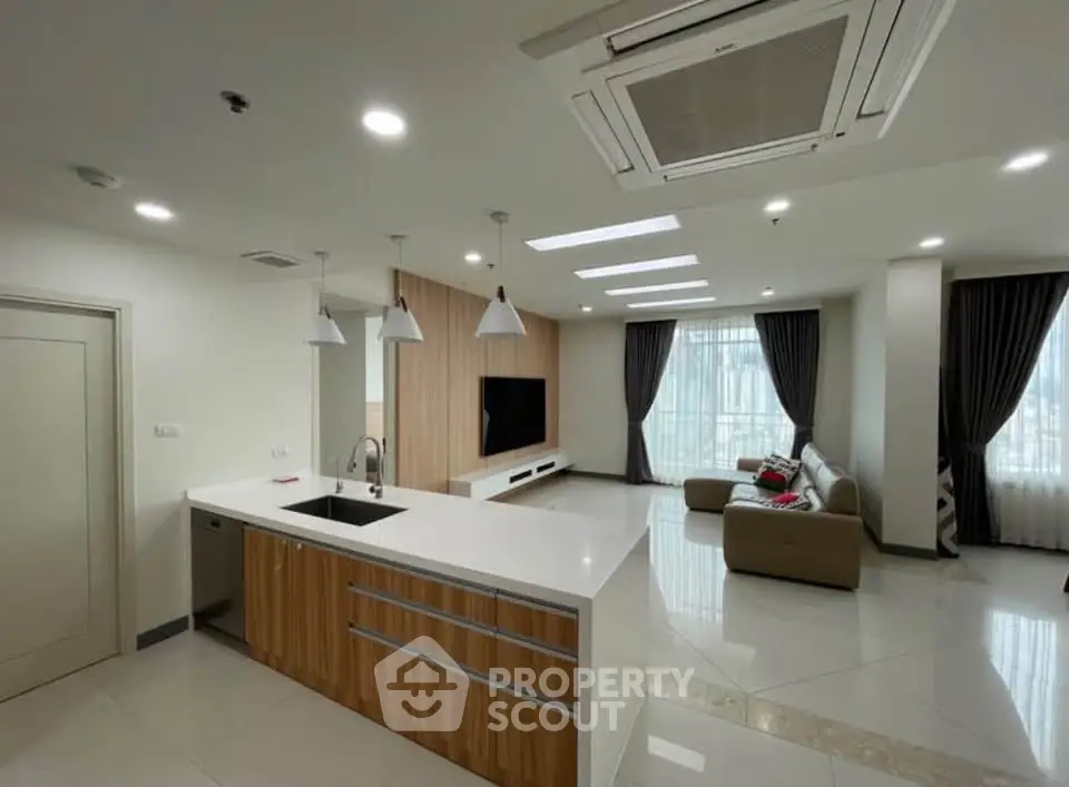 Spacious modern living room with open kitchen and elegant decor