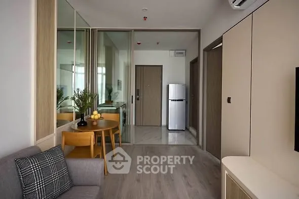 Modern apartment interior with sleek design and open layout, featuring a cozy living area and stylish kitchen.