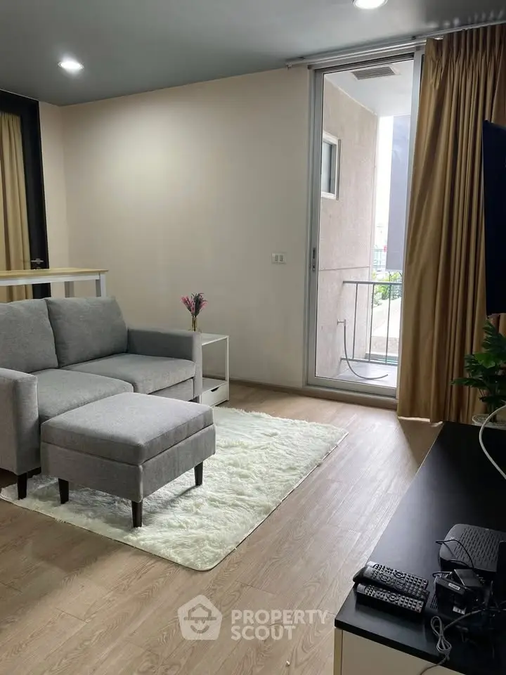 Modern living room with cozy sofa and balcony access in stylish apartment
