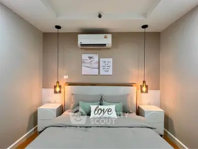 Cozy bedroom with modern decor, featuring a comfortable bed, stylish lighting, and air conditioning.