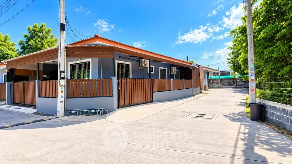 Charming single-story home with modern exterior and fenced yard in a peaceful neighborhood.