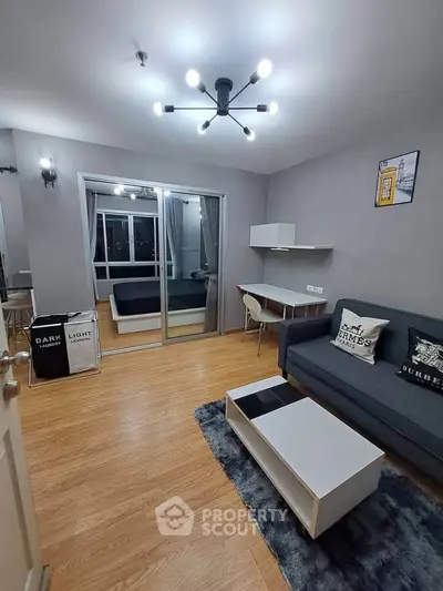 Modern living room with stylish lighting and cozy decor in a contemporary apartment.