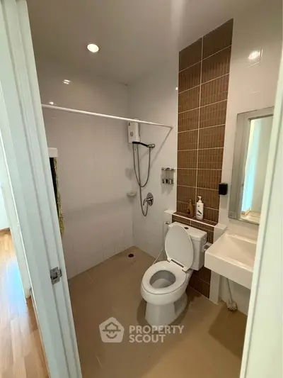 Modern bathroom with sleek fixtures and tiled walls in a contemporary home.