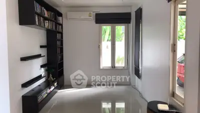 Spacious living room with modern shelving and natural light