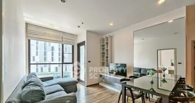 Modern living room with sleek furniture and large window view