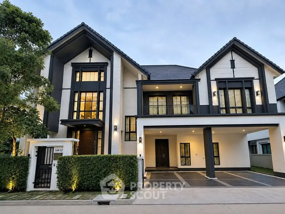 Stunning modern two-story house with elegant facade and lush greenery, perfect for luxury living.