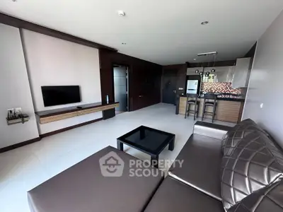 Modern living room with sleek furniture and open kitchen layout
