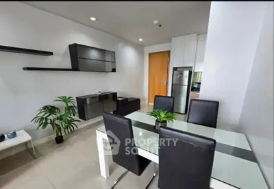 Modern dining area with sleek furniture and stylish decor in a contemporary apartment.