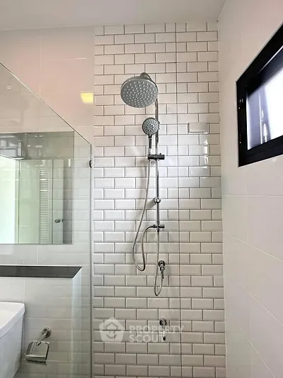Modern bathroom with sleek shower and white subway tiles