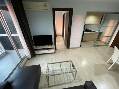 Modern living room with sleek furniture and open kitchen layout in a stylish apartment.