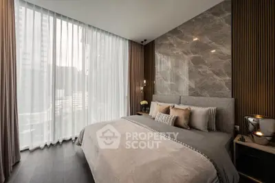Luxurious modern bedroom with floor-to-ceiling windows and elegant decor in urban high-rise.