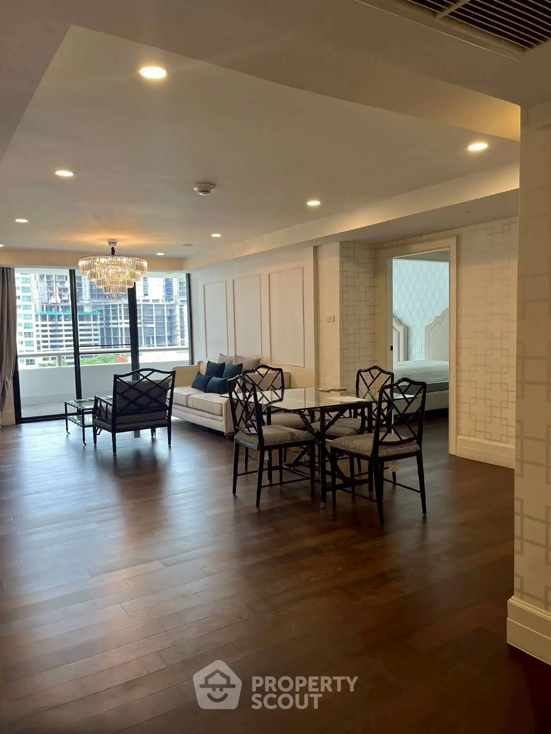 Spacious modern living room with elegant furniture and city view, perfect for urban living.