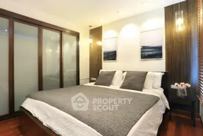 Elegant bedroom with modern decor and cozy ambiance, featuring a large bed and stylish lighting.