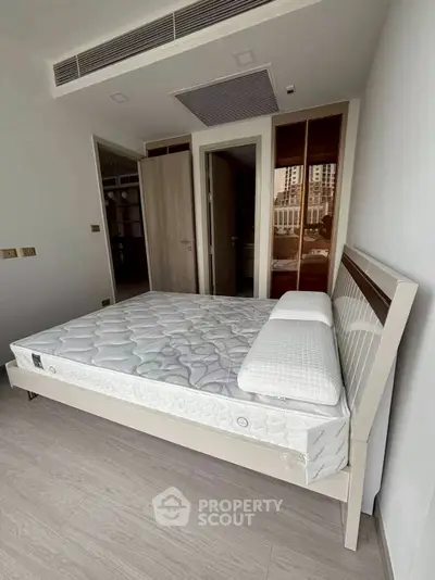 Modern bedroom with sleek design and large windows offering ample natural light.