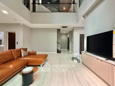 Spacious modern living room with high ceiling and elegant leather sofa